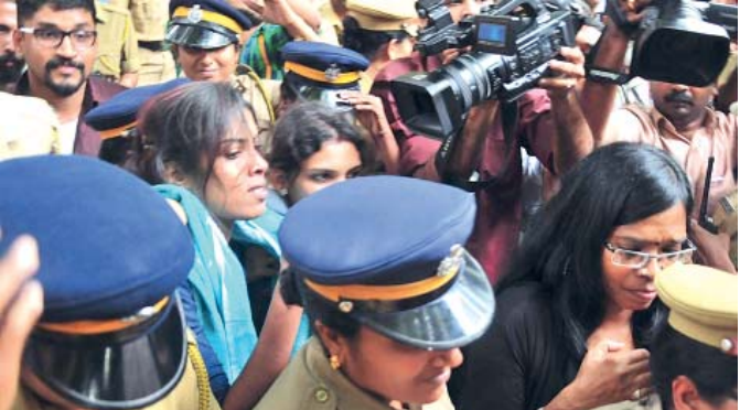 Police arresting kiss of love organizers when they came out of law college to protest