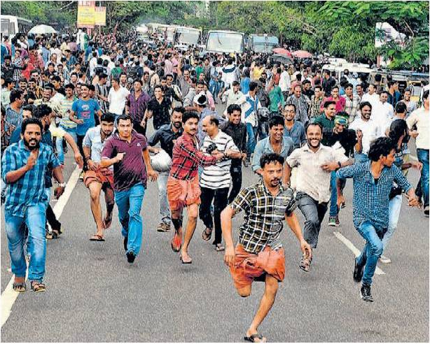 Spectators running on police lathi charge