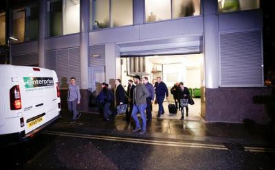 A van and a group of people leave the building which houses the offices of Cambridge Analytica as investigators from Britain’s Information Commissioners Office entered, following the granting of a search warrant by a High Court judge, in London