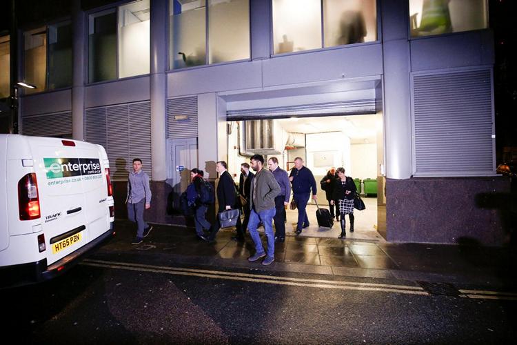 A van and a group of people leave the building which houses the offices of Cambridge Analytica as investigators from Britain’s Information Commissioners Office entered, following the granting of a search warrant by a High Court judge, in London