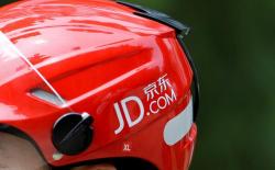 FILE PHOTO: Logo of JD.com is seen on a helmet of a delivery man in Beijing