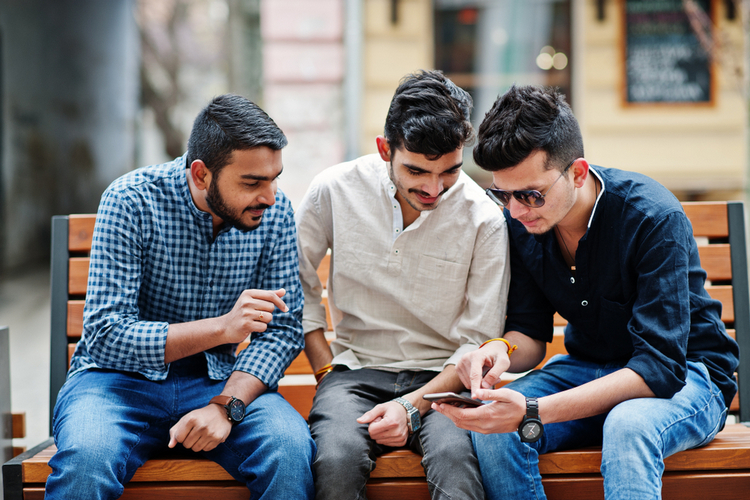 Indian youth using smartphones shutterstock website