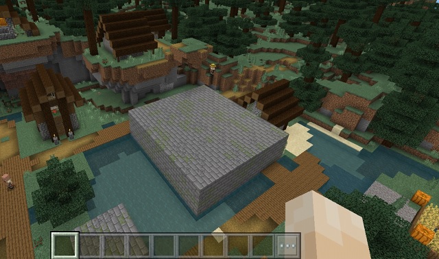 Entrazione di roccaforte esposta e biblioteca in un villaggio di spawn con semi di Minecraft Pocket Edition