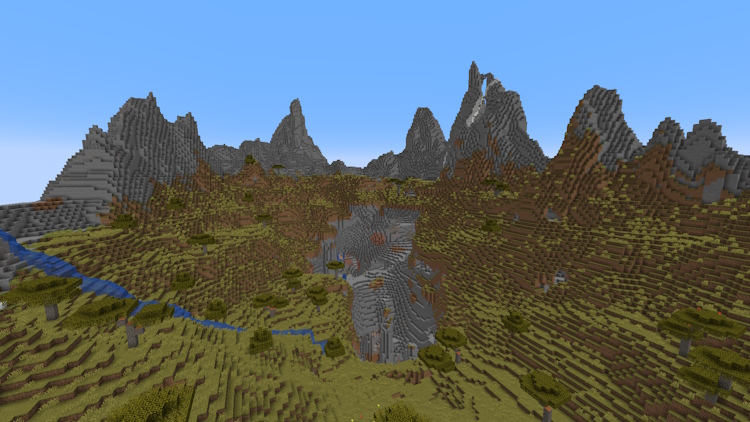 Stony peaks in a savanna biome with a large cave opening in the center, leading to a dripstone cave