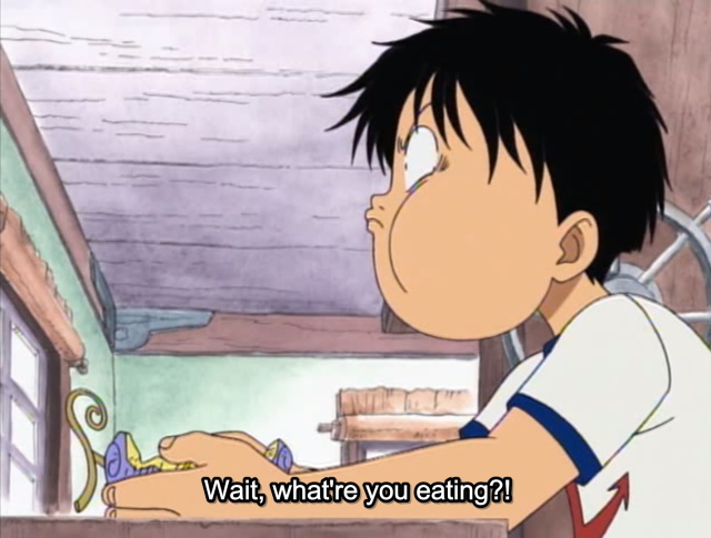 An image of Luffy eating a devil fruit from One Piece.