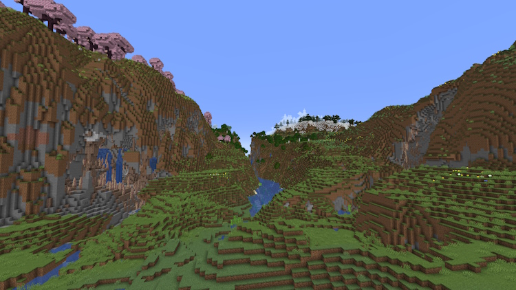 Canyon cutting through tall terrain of a cherry grove and meadow biomes