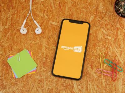 Amazon Pay on an iPhone placed on an orange background