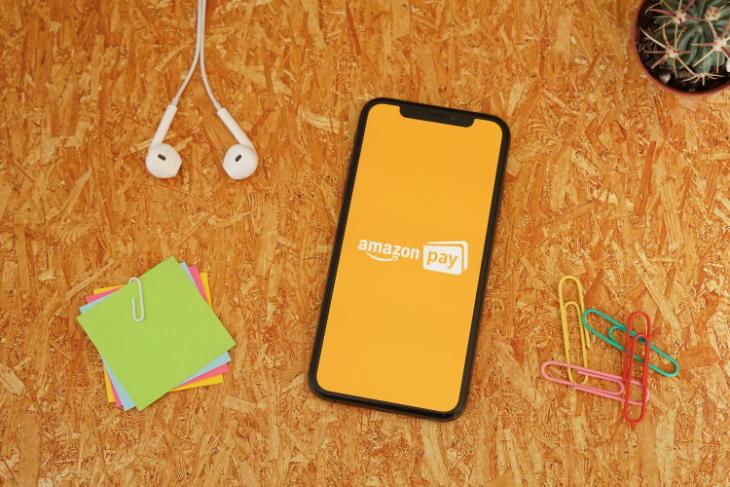 Amazon Pay on an iPhone placed on an orange background