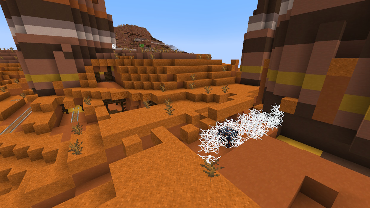 Badlands variant of mineshafts in Minecraft with an exposed cave spider spawner on the surface