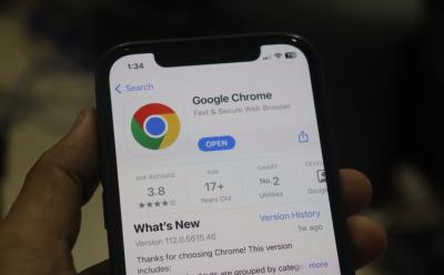 The Google Chrome app installed on an iPhone and is held by a hand