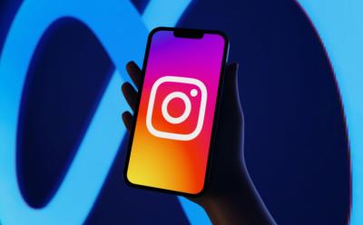 Instagram logo on an iPhone, with the Meta logo as the backdrop