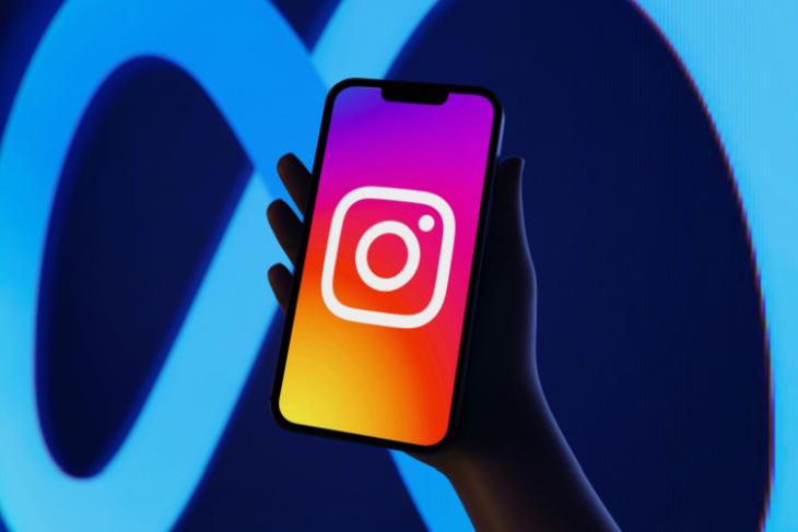 Instagram logo on an iPhone, with the Meta logo as the backdrop