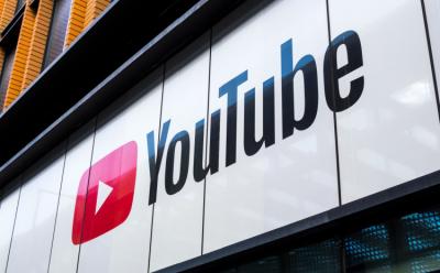 This image depicts a billboard with the YouTube name and logo on it