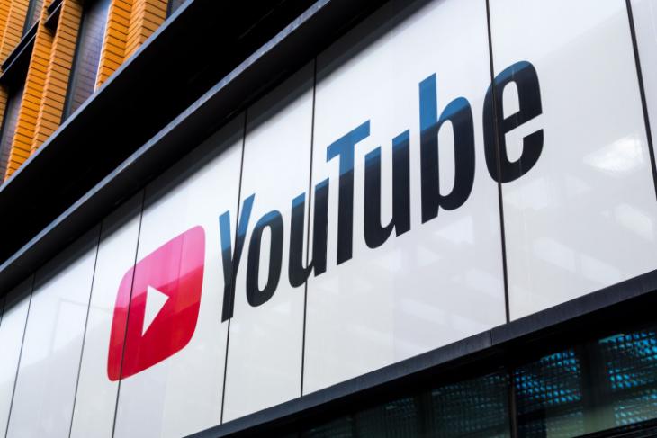 This image depicts a billboard with the YouTube name and logo on it
