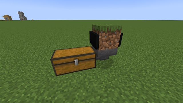 Minecart inside a grass block with a hopper below facing into a chest