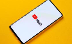 YouTube Music logo on a smartphone placed on a yellow background