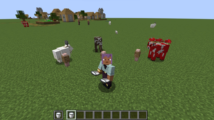 A cow, a mooshroom and a goat tied next to the player