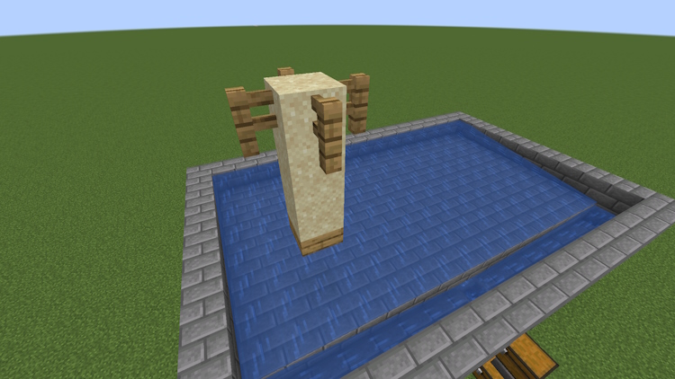 Slab with three sand blocks on top and fences connected to the topmost sand block, all above the water platform