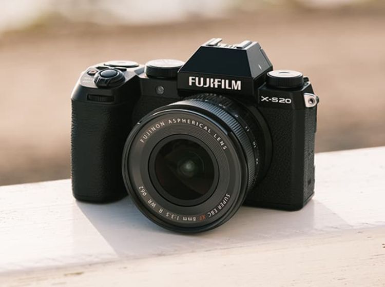 FUJIFILM X-S20 placed on a white surface with a brown background