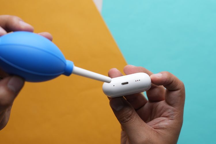 Use a manual blower to clean AirPods Case Charging port
