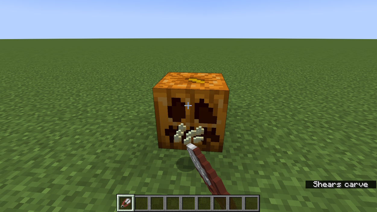 Shearing a pumpkin to make a carved pumpkin in Minecraft