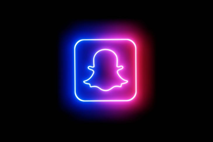 The Snapchat logo placed on a black background and is represented with blue and pink neon colors