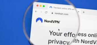This image depicts the Nord VPN webpage under a magnifying glass