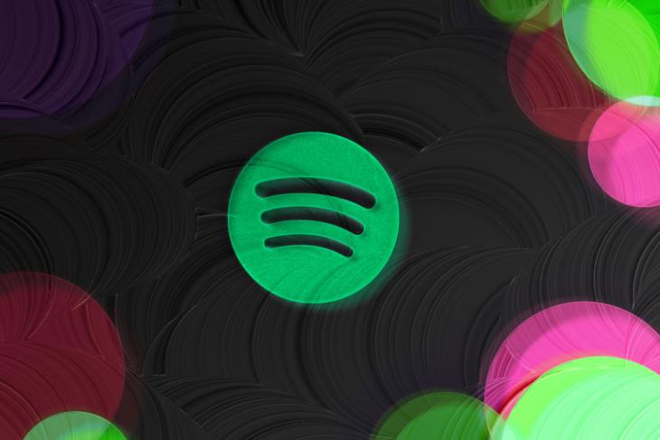 This image depicts the Spotify logo placed in a black background with colored corners