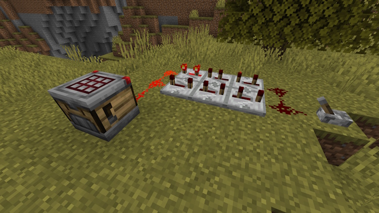 A small redstone clock behind the crafter in Minecraft 1.21