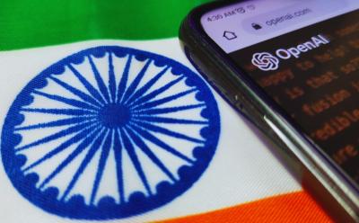 smartphone with openai website open in a browser and it is placed atop the indian flag