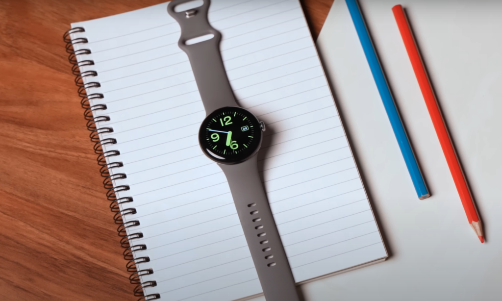 Pixel watch laying  on a notebook