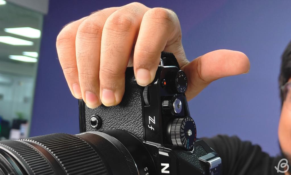 Holding the grip of the Nikon Zf with one hand