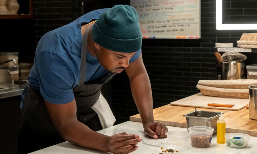 Lionel Boyce taking notes as Marcus Brooks in The Bear