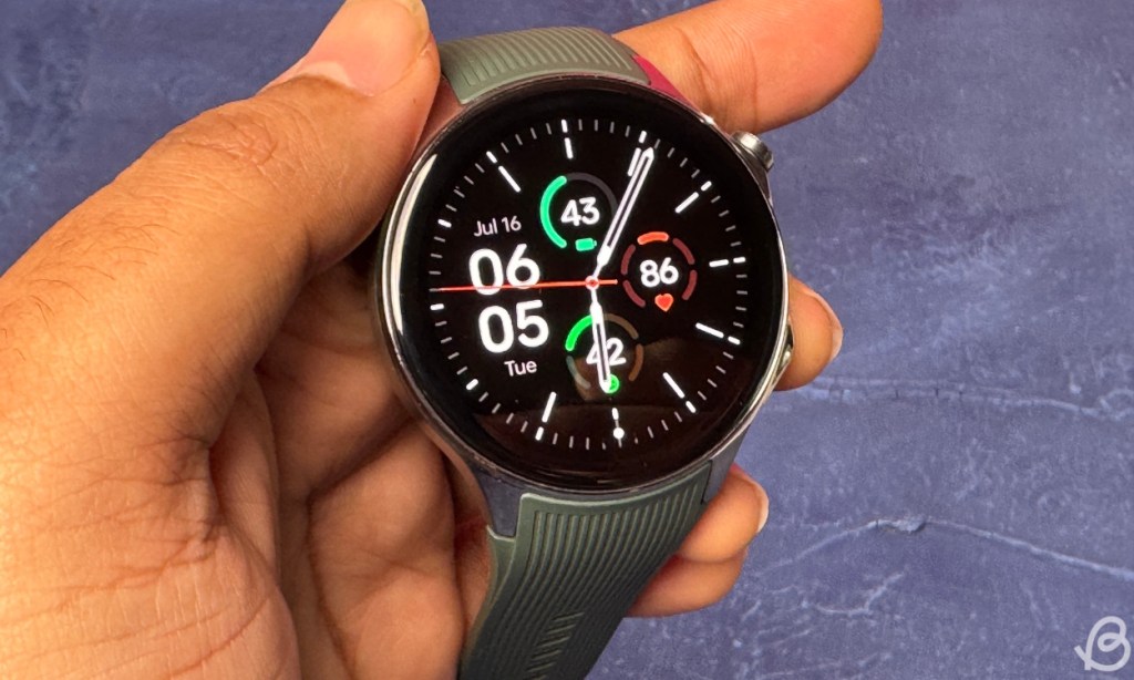 person holding OnePlus Watch 2 showing the display and watch face