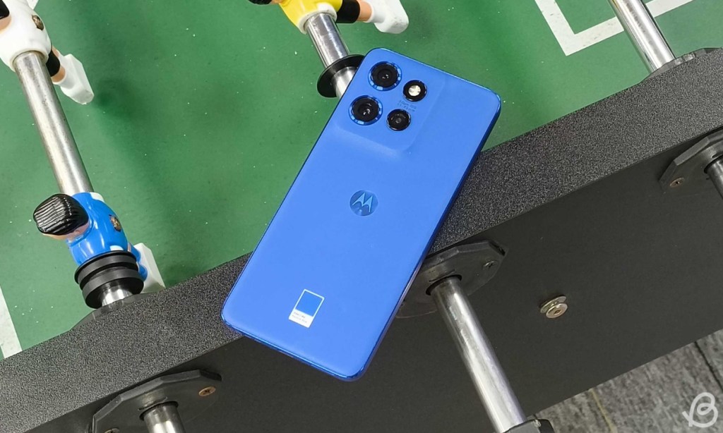 Motorola Edge 50 Neo in Blue colorway placed face downwards on a foosball table