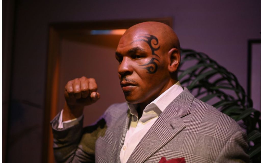  Mike Tyson in a suit making a fist