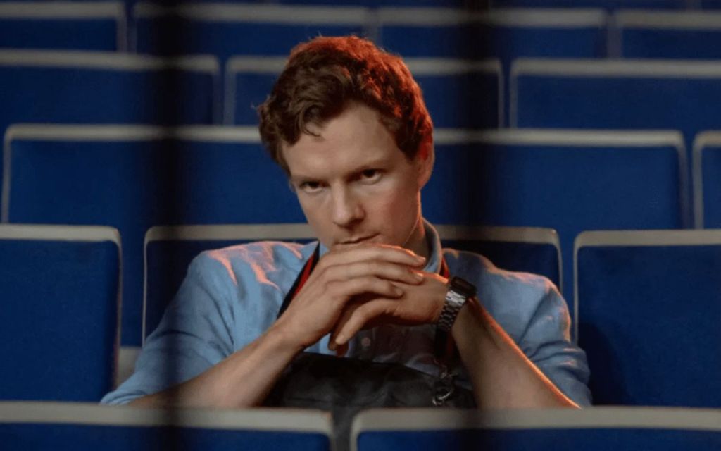 Patrick Gibson As Dexter Morgan sitting in a stadium bench