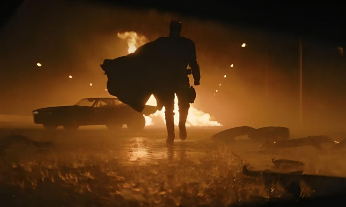 Batman walking away from an explosion