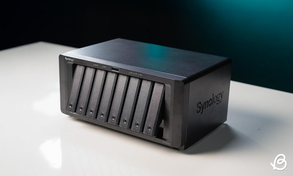 Synology DS1823xs+ on a desk with the disk bays partially open