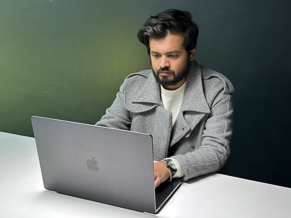 Photo of a person (Akshay Gangwar from Beebom) using the M4 Pro MacBook Pro