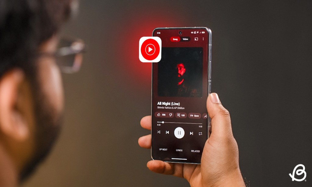 person holding a phone with the YouTube Music app open