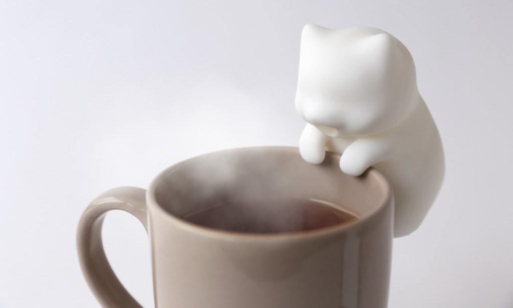 Nekojiji FuFu mini robot made by Yukai Engineering mounted on a cup with hot liquid