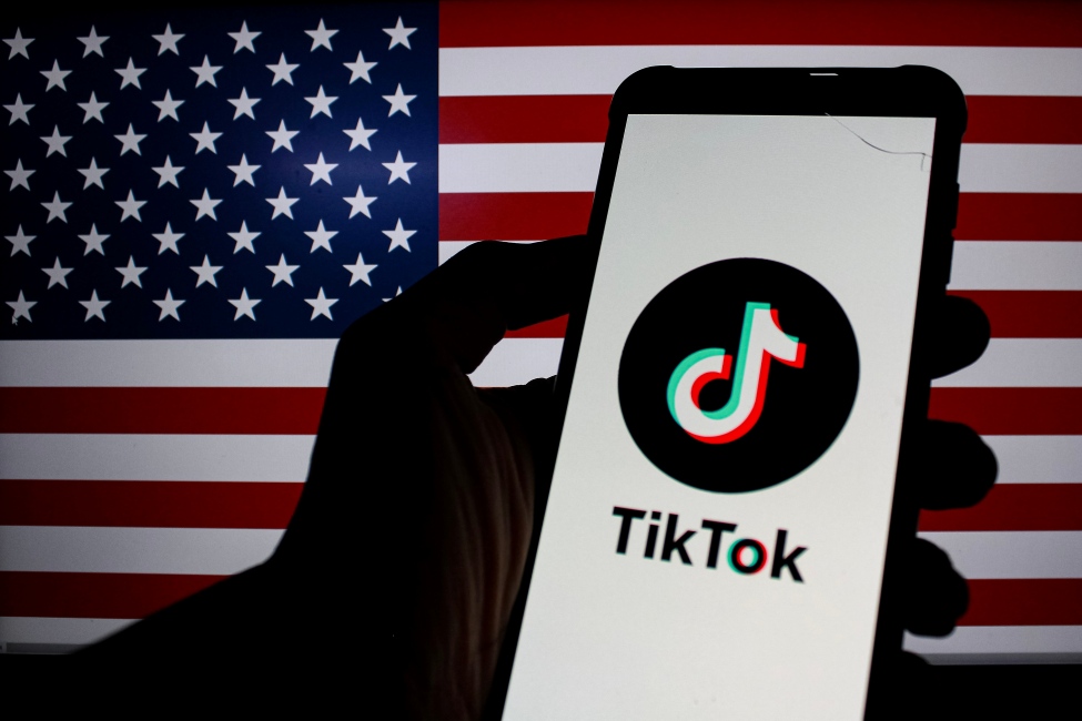 TikTok App on a Phone In front of the American Flag