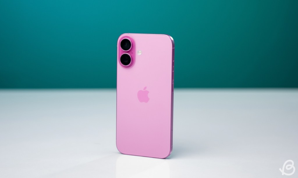 shot of the rear side of the iPhone 16 in pink colorway against a turqoise backdrop