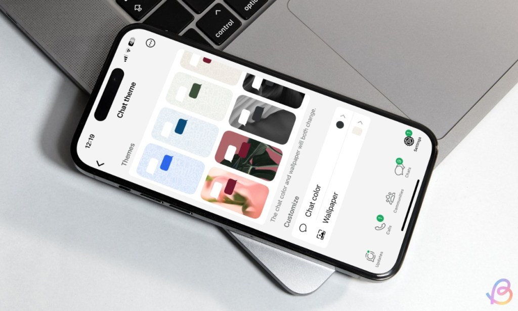 shot of an iPhone placed on top of a macbook previewing the Chat theme screen inside the WhatsApp app on iOS